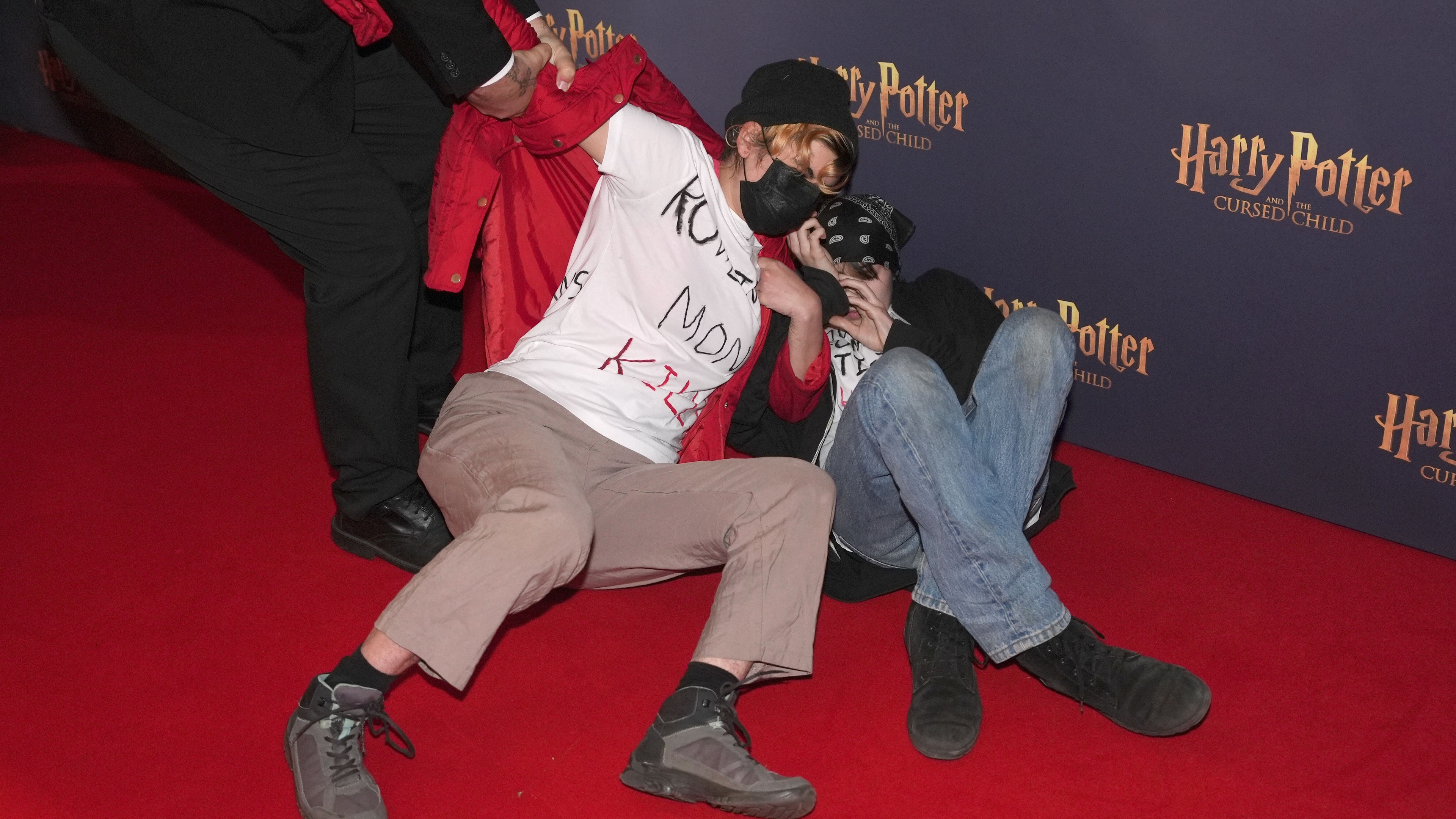 UK Trans rights activists rush carpet before Harry Potter And The Cursed Child show