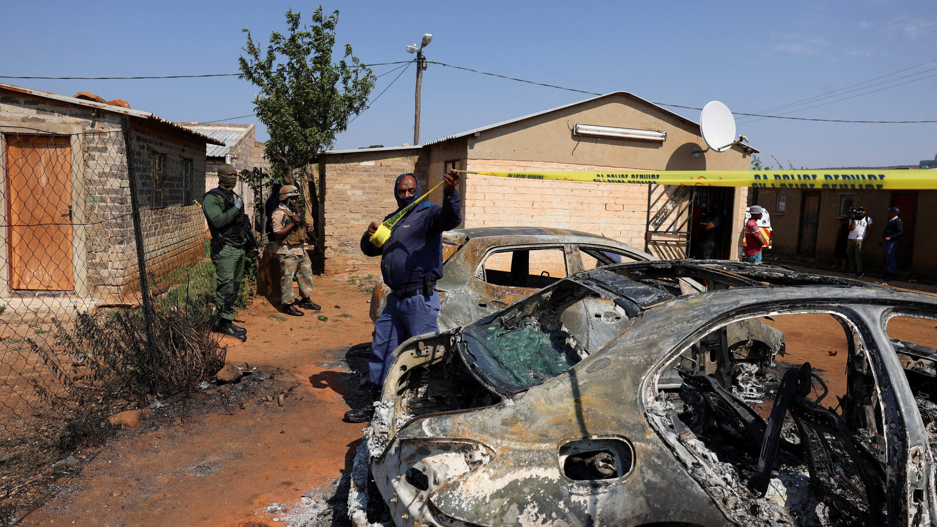 Hunt for multiple gunmen as two mass shootings in South Africa leave at least 27 dead