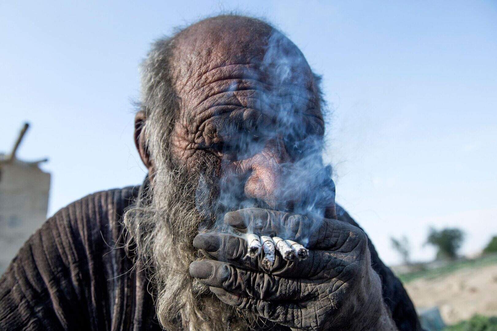 Amou Haji would smoke several cigarettes at the same time. Photo: AFP via Getty Images