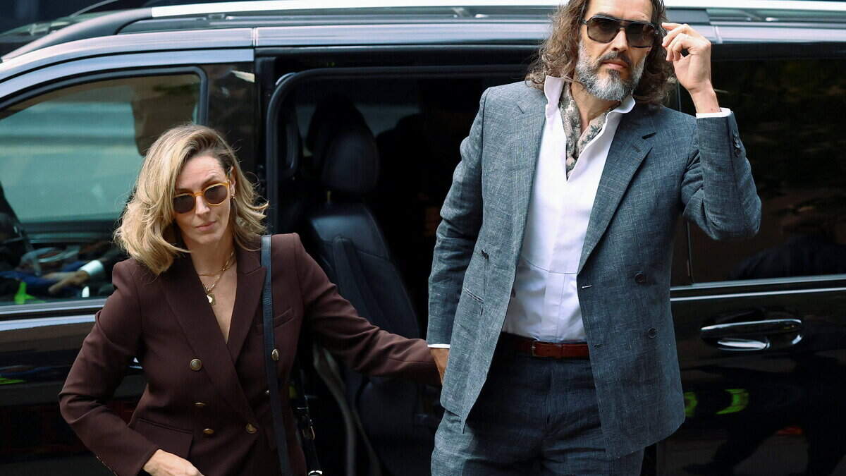 Russell Brand's publicity-shy wife won't abandon him as couple arrive together for start of actor's rape and sexual assault trial