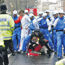 Chaotic scenes of police scuffling with anti-China campaigners as the Olympic torch made
its way through London