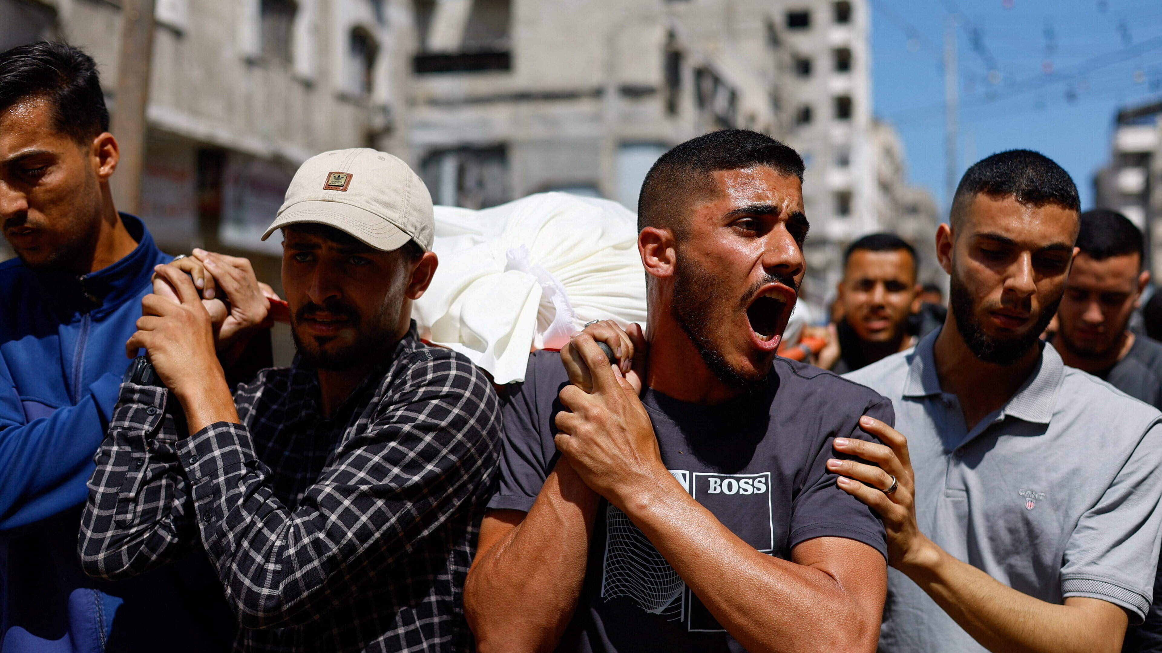 Hamas military leader's body carried through streets of Gaza after he is killed in Israeli strike