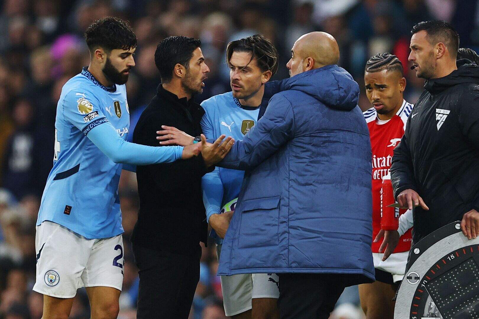Arsenal manager Mikel Arteta and Manchester City boss Pep Guardiola as Manchester City's Jack Grealish grabs the ball in a heated clash REUTERS/Molly Darlington