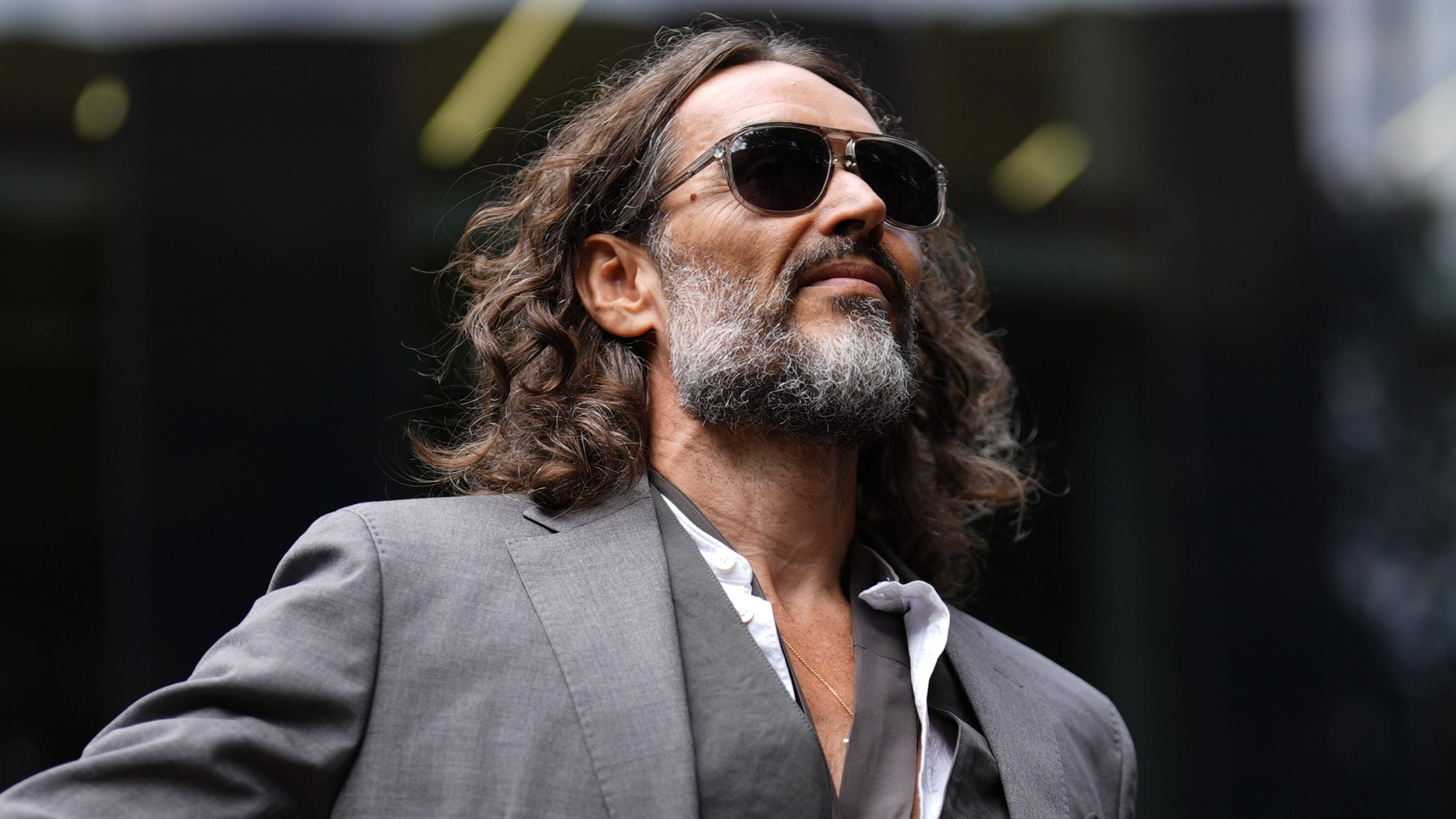 Russell Brand arrives at UK court for hearing ahead of rape trial