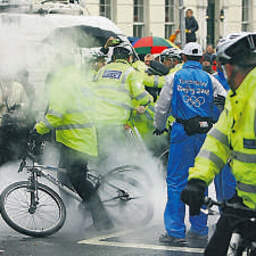 A demonstrator sets off a fire extinguisher at the lighting of the Olympic cauldron at the O2 Arena in Greenwich