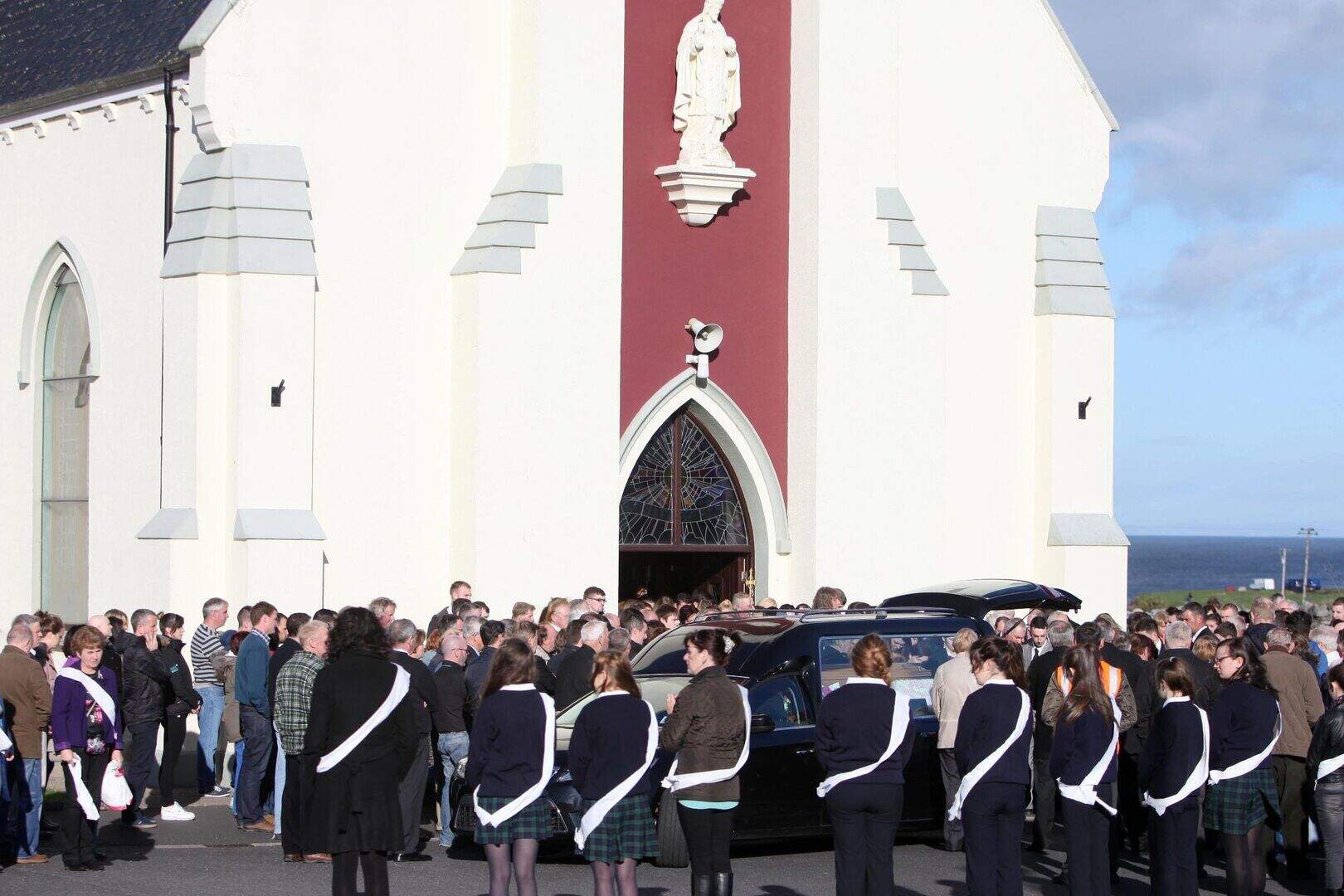 Mourners outside the church at the funeral of childcare worker Natalie McGuinness, 23, on Saturday in her home village of Easkey