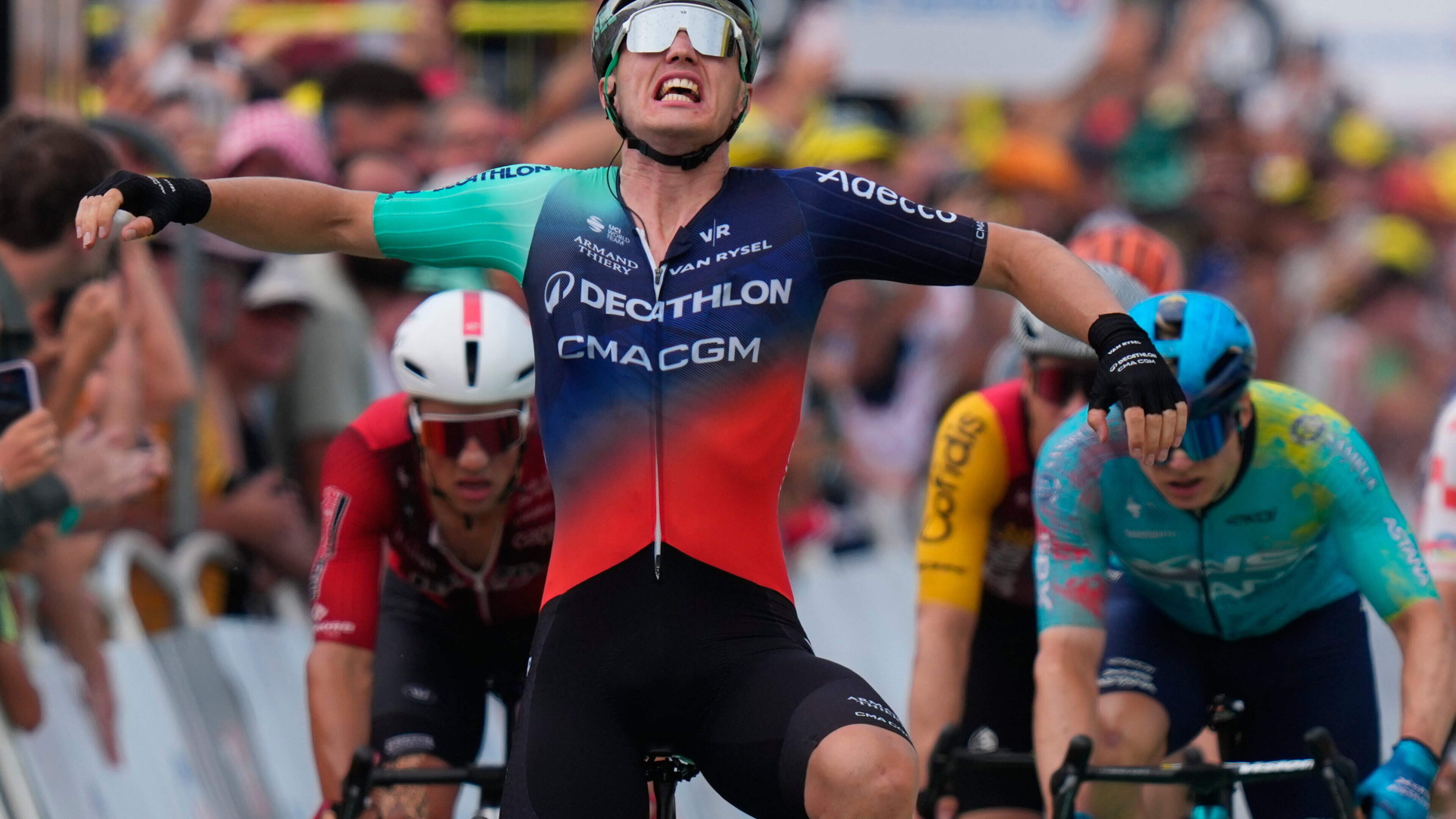 Dutch rider Olav Kooij takes his first Tour de France stage win after surviving late drama