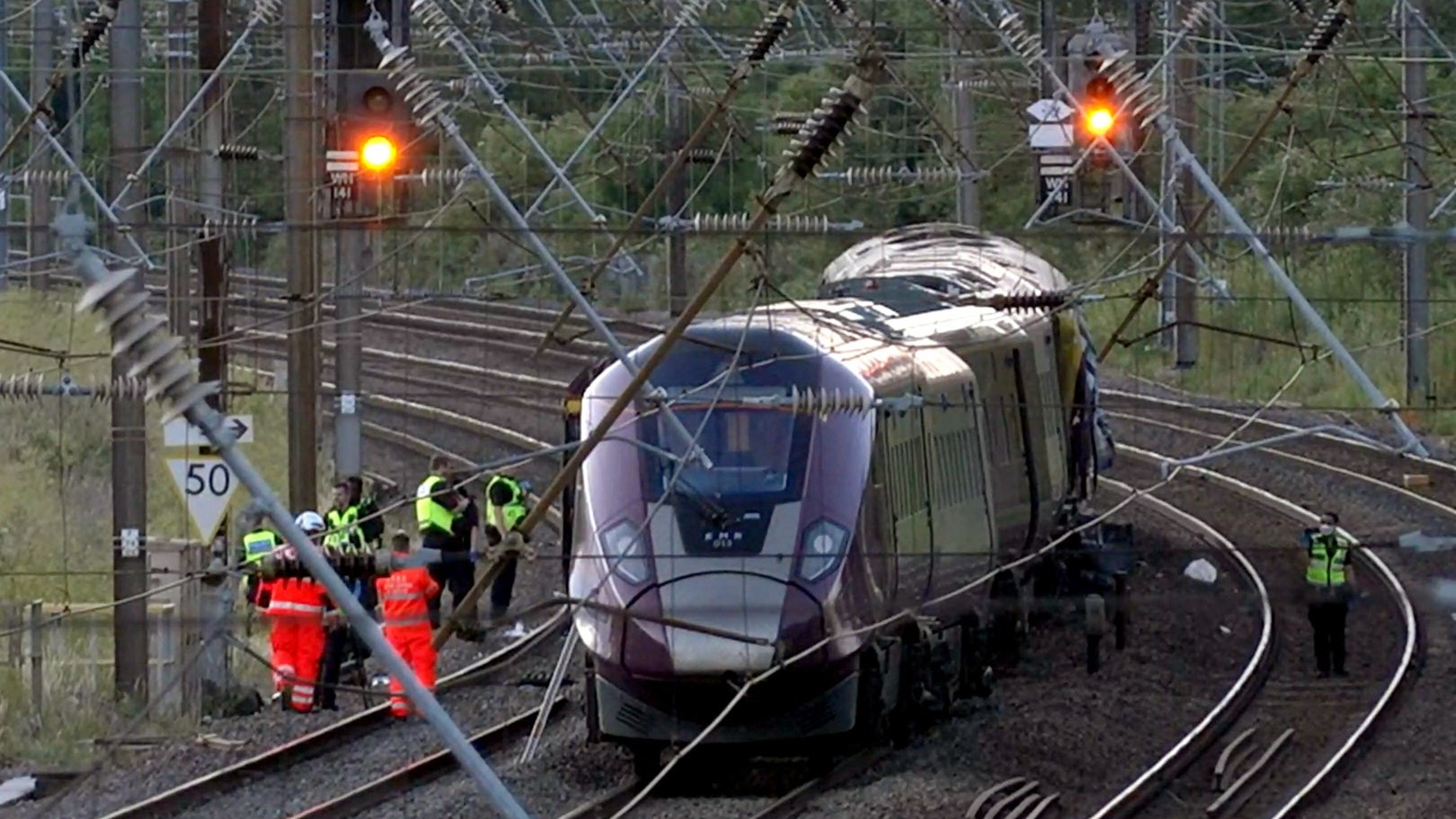 Train driver killed and dozens injured as two trains collide north of London