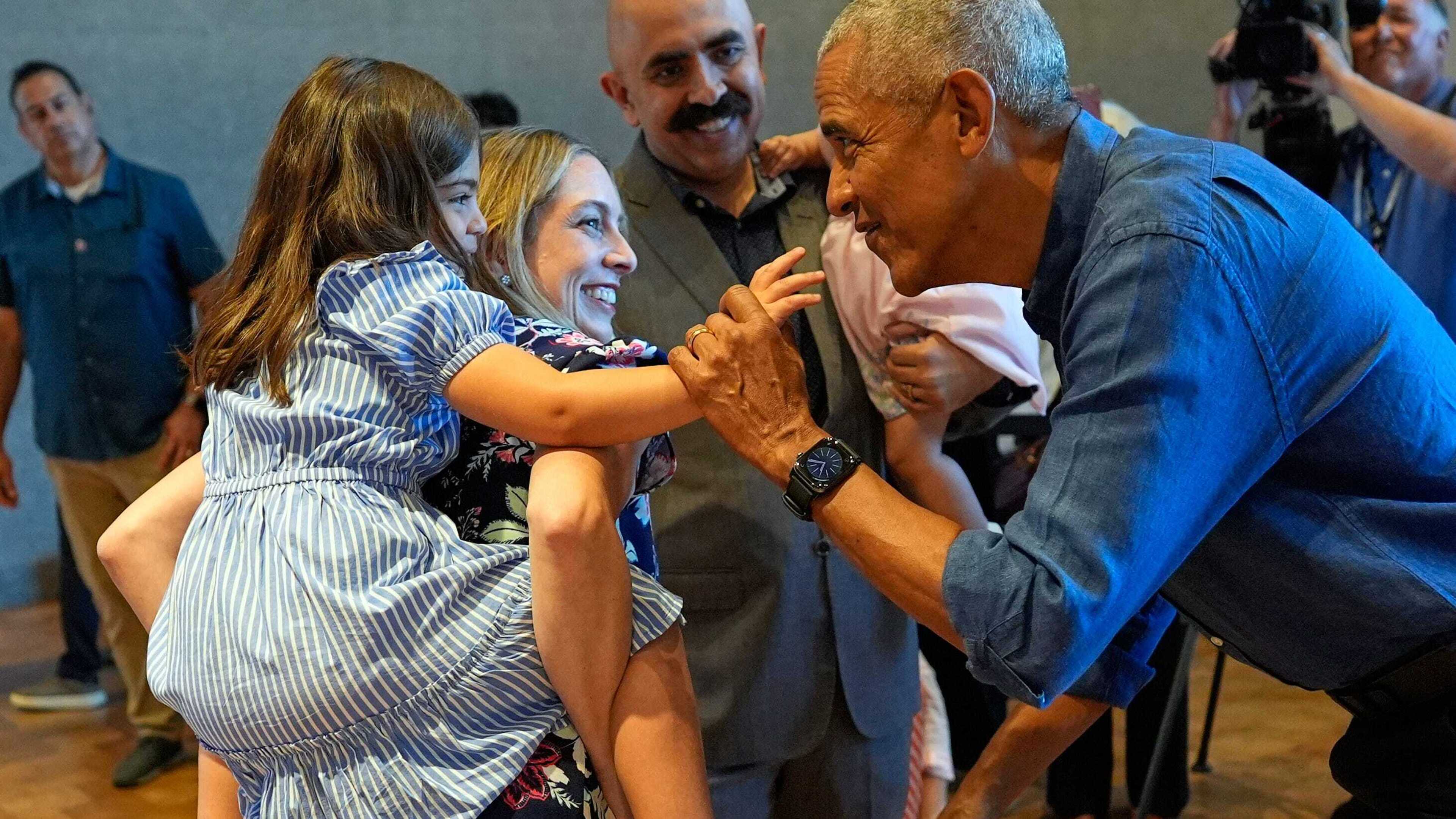 Barack and Michelle Obama surprise first visitors to new presidential centre